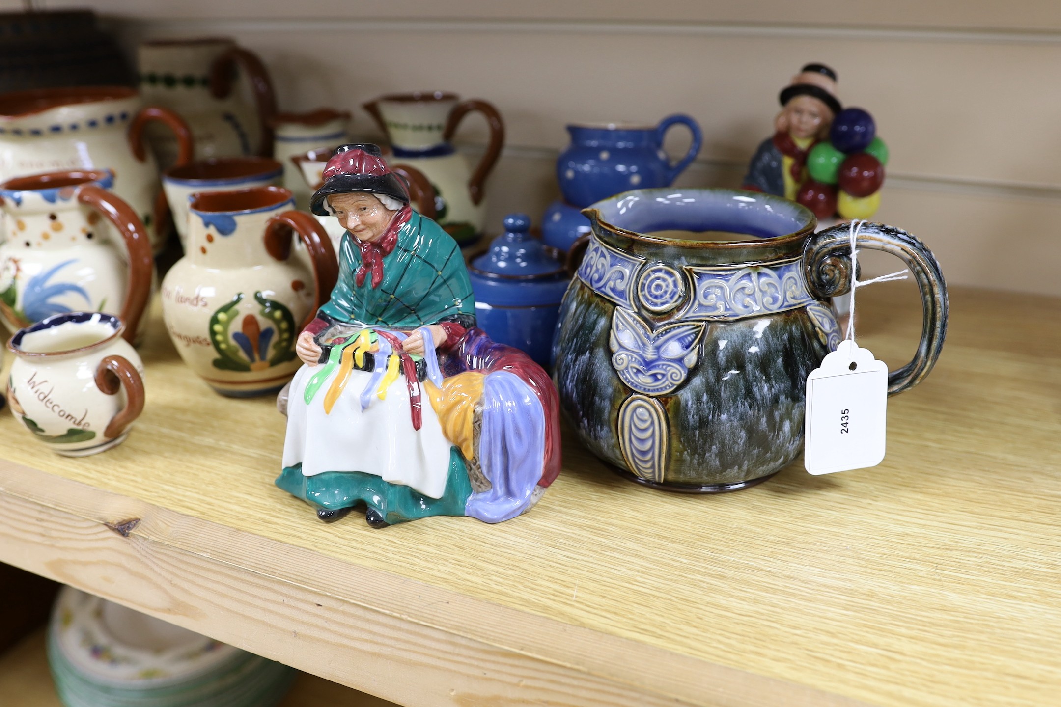 A collection of Doulton vessels and Torquay Mottoware